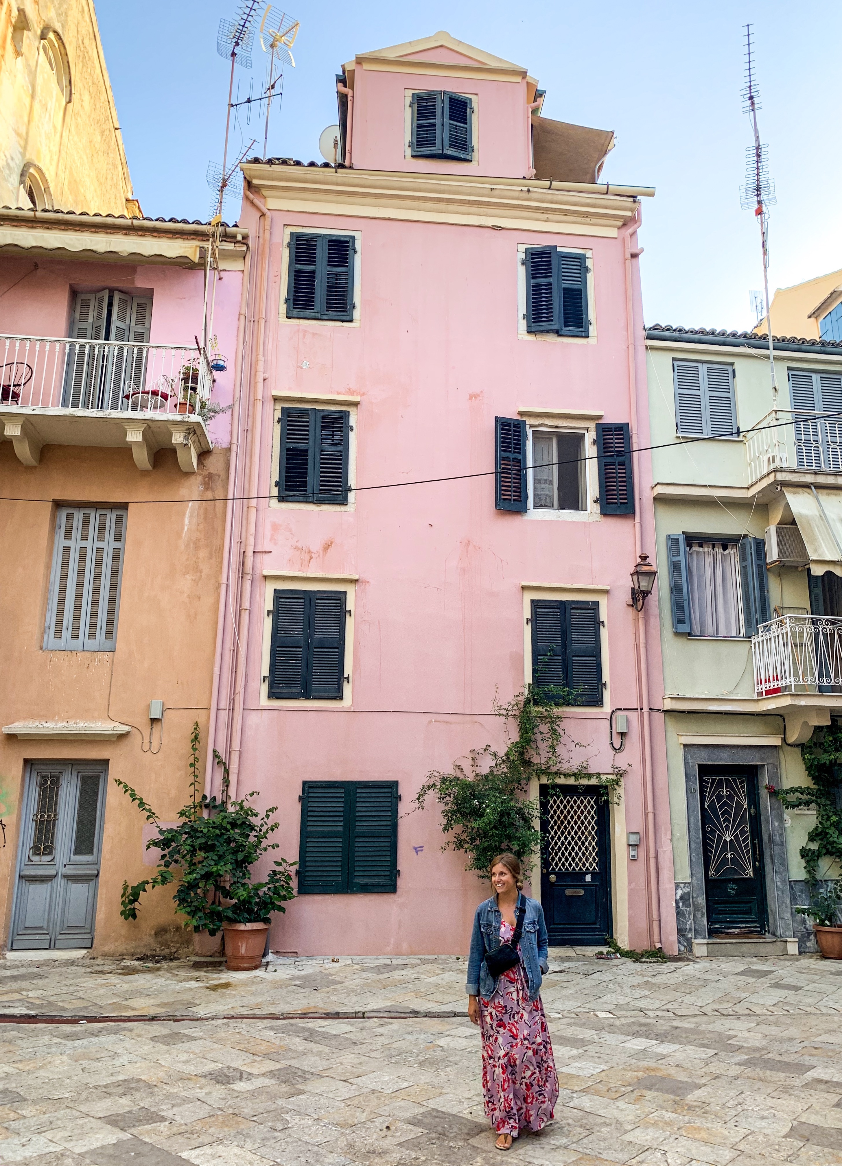 Posing infant of the pink houses in Corfu