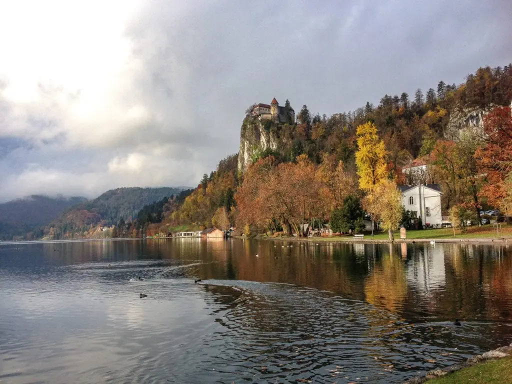 Photo of a lake with a castle in the background