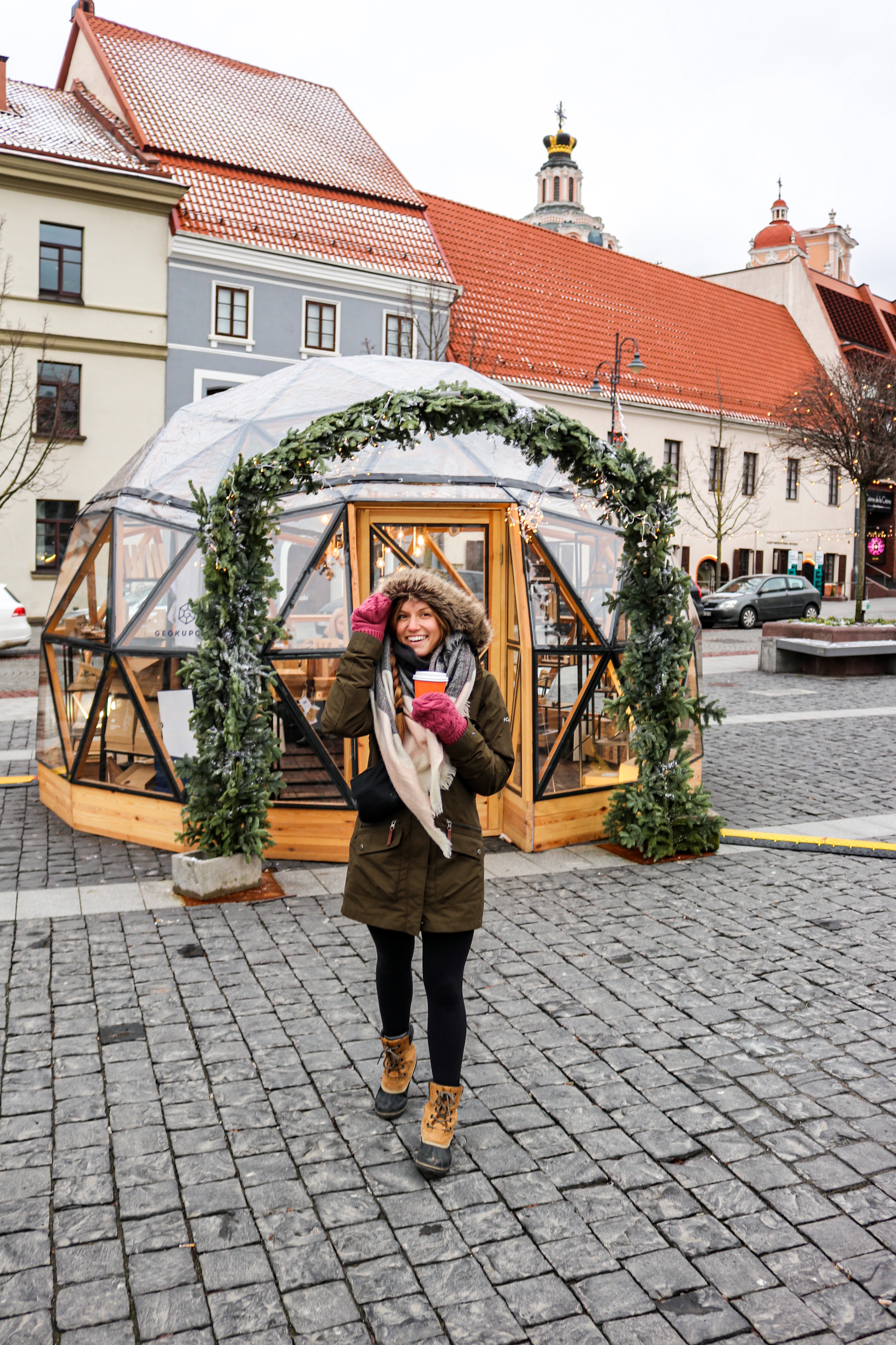 Photo in front of a snowglobe at the Christmas Market in Vilnius, Lithuania