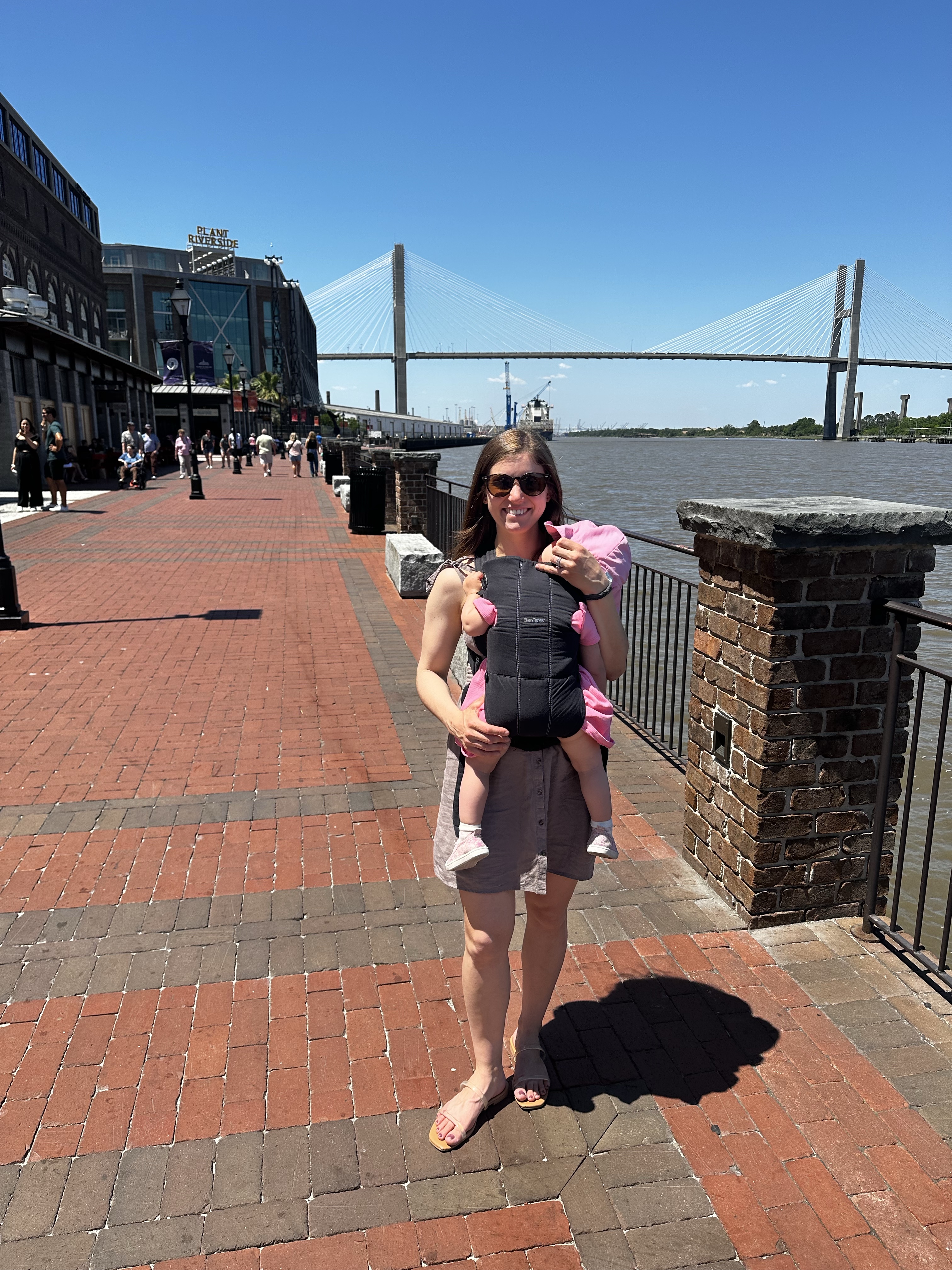 Posing with a view of the Savannah River from River Street in Savannah GA