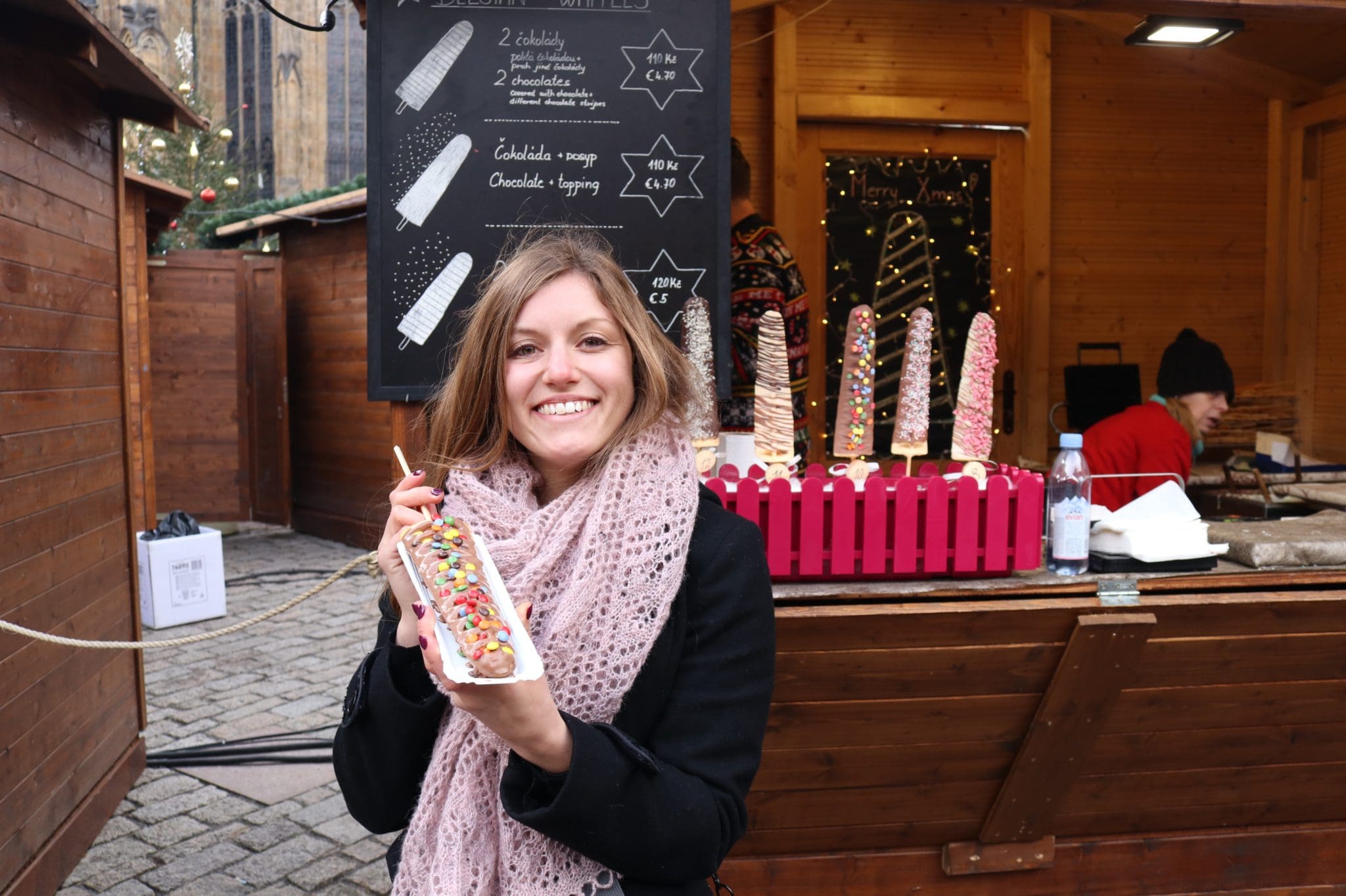 Photo of me holding a waffle at the Christmas market in Prague